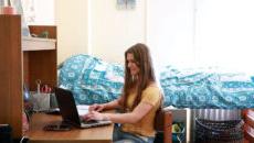 A student working on a computer in a dorm room